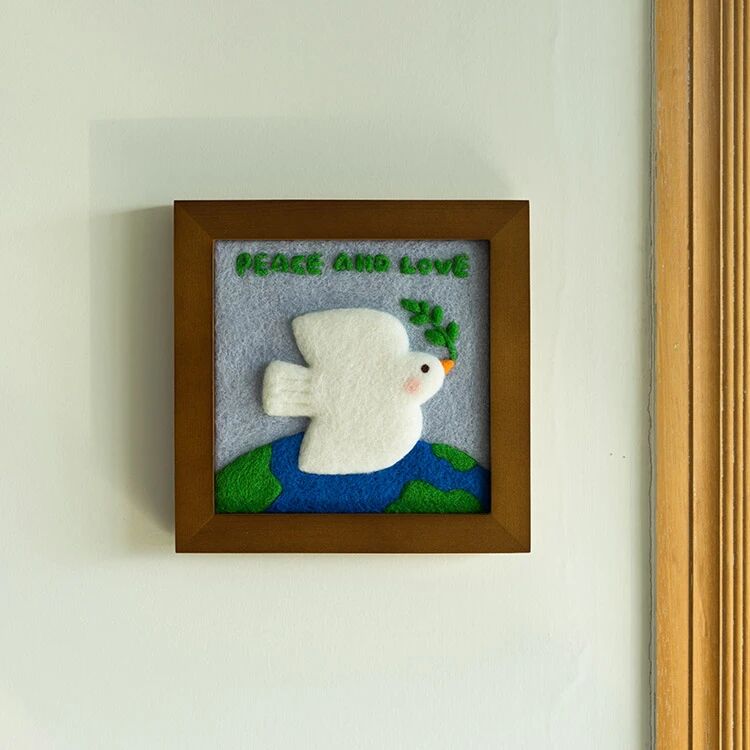Finished Peace Dove felt frame with white dove and olive branch.