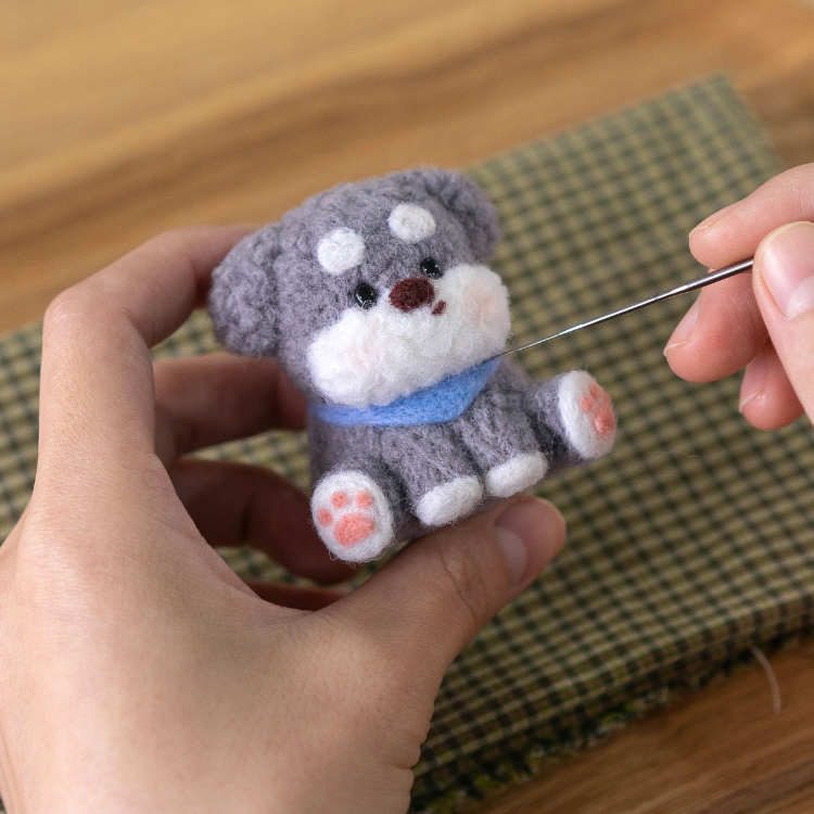 Finished Faithful Schnauzer felt dog with blue scarf.