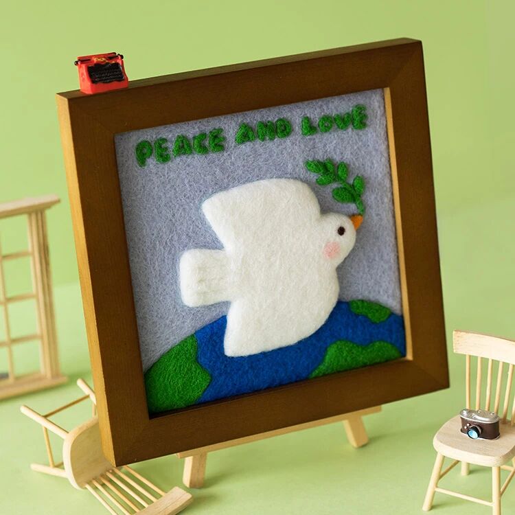 Finished Peace Dove felt frame with white dove and olive branch.