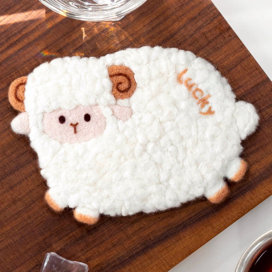 Finished Lucky Sheep felt coaster with curly wool and ‘Lucky’ text.