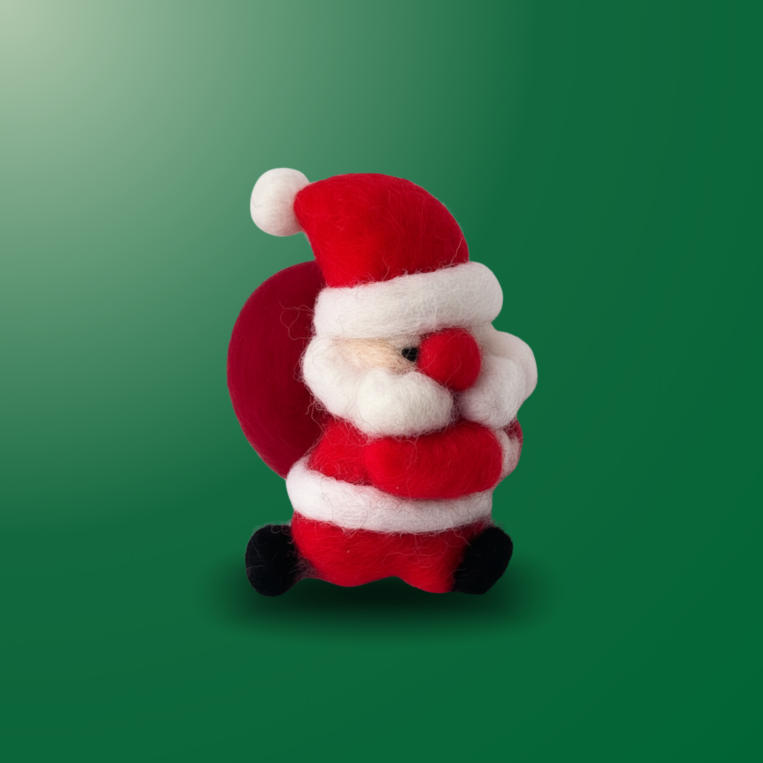 Run-Run Santa, a cute beginner-friendly needle felting wool Santa with a gift bag, red outfit, fluffy beard, and rounded body, part of Joypok Christmas DIY kit.