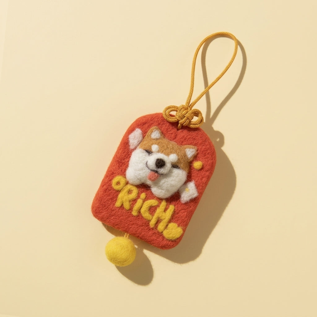 Finished Richshiba good fortune wool felt charm in red with a shiba inu and gold bead, made from the Joypok beginner needle felting kit