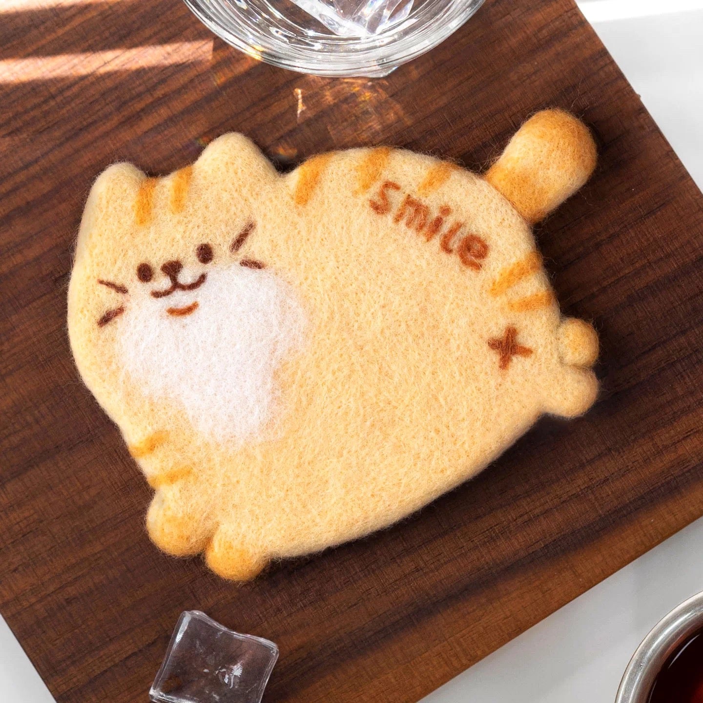 Finished Smile Cat felt coaster with orange cat and ‘Smile’ text.