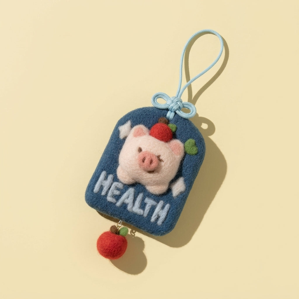 Finished Healpy good health wool felt charm with a pig and strawberry, made from the Joypok beginner needle felting kit