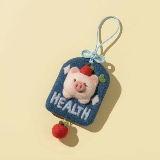 Finished Healpy good health wool felt charm with a pig and strawberry, made from the Joypok beginner needle felting kit
